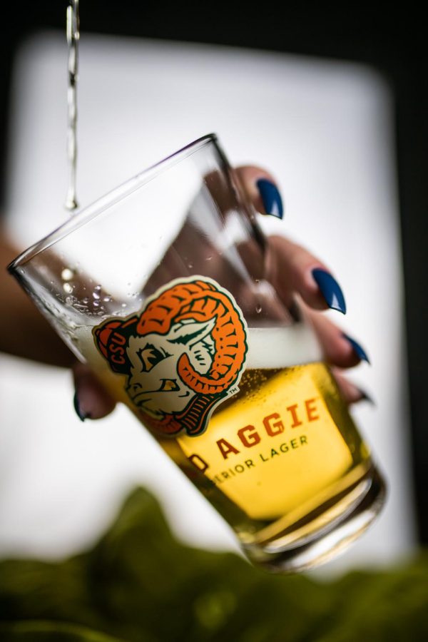 A can of New Belgium Brewing's Old Aggie lager is poured into a pint glass