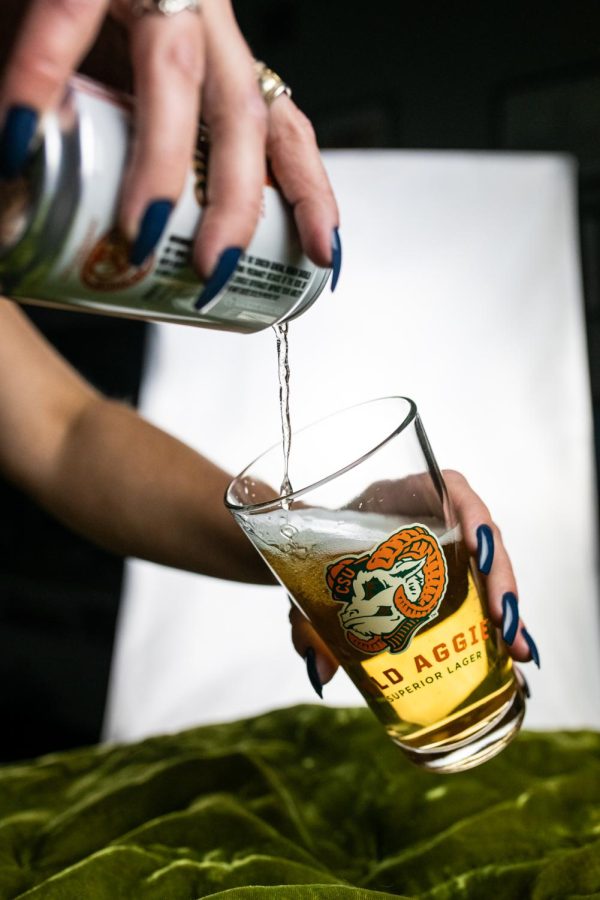 A can of New Belgium Brewing's Old Aggie lager is poured into a pint glass