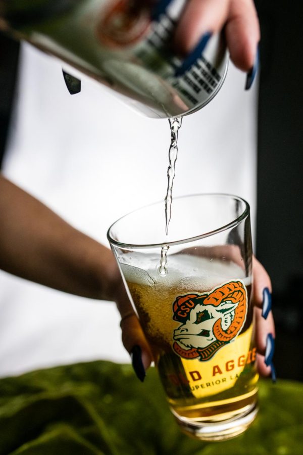 A can of New Belgium Brewings Old Aggie lager is poured into a pint glass