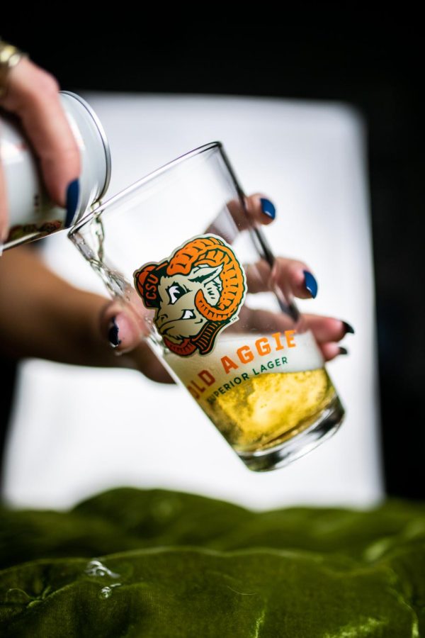 A can of New Belgium Brewing's Old Aggie lager is poured into a pint glass