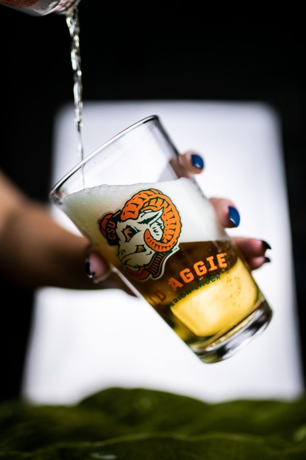 A can of New Belgium Brewing's Old Aggie lager is poured into a pint glass