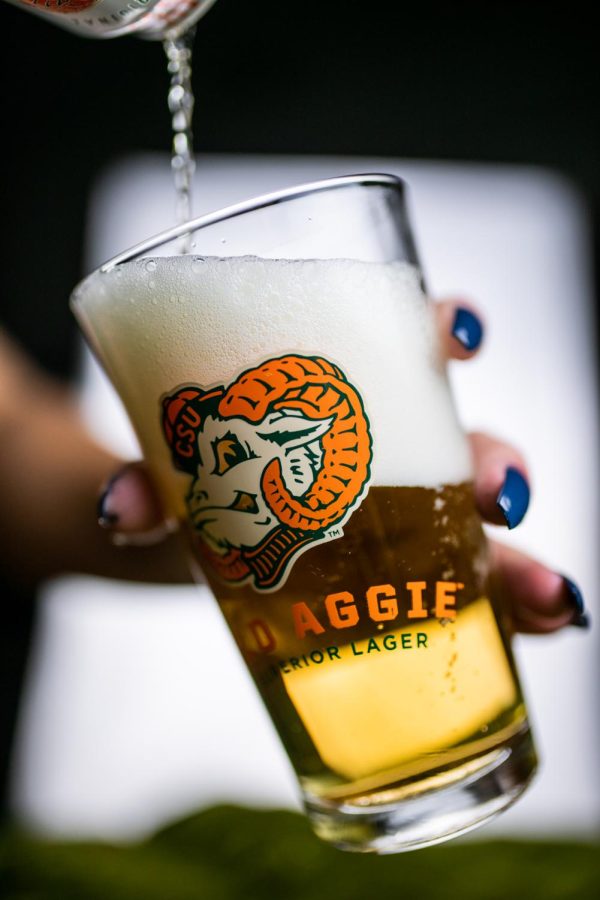 A can of New Belgium Brewing's Old Aggie lager is poured into a pint glass