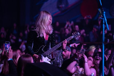 Demi Demitro, lead singer of The Velveteers, stands in the middle of the crowd while playing an original song April 16.
