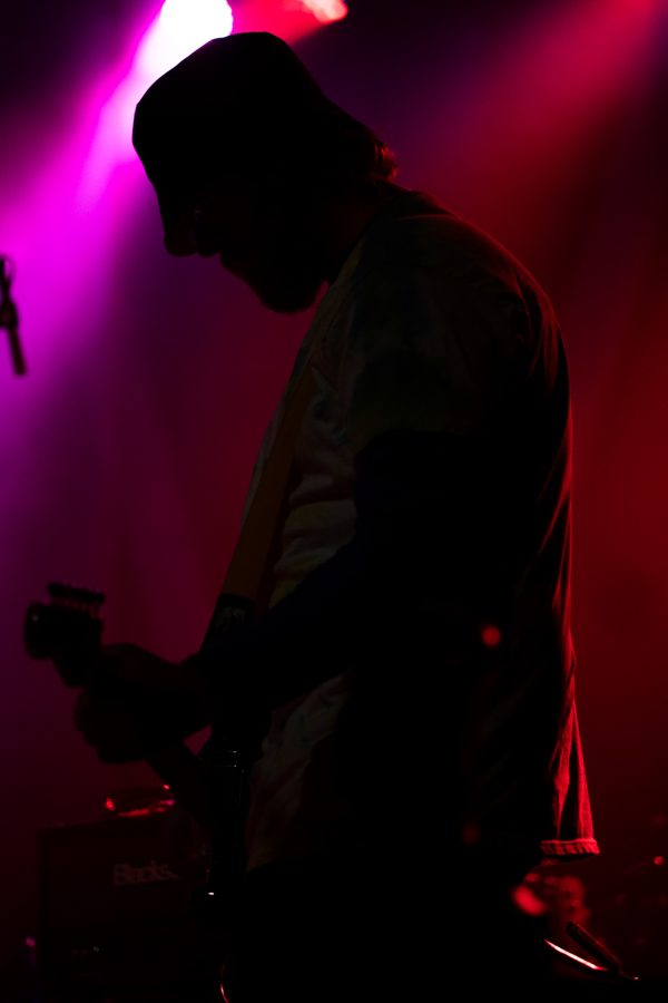 Oliver Mueller, bassist, strums to an original song by his band Cody at The Aggie Theatre April 16. Jakob Mueller, the lead singer of Cody, is Oliver’s brother.