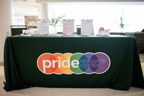 A Pride Resource Center table stands outside of the entrance to the drag show offering stickers and information