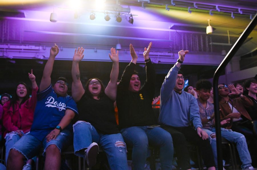 Audience members cheer during a drag artist’s performance