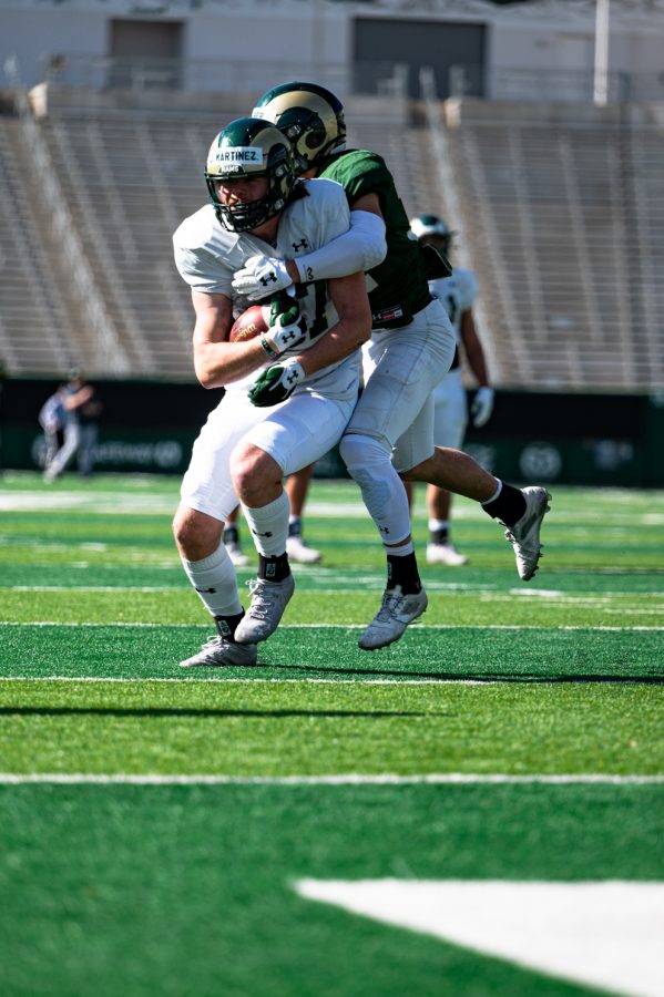 Colorado State University tight end Drake Martinez gets tackled during practice in Canvas Stadium