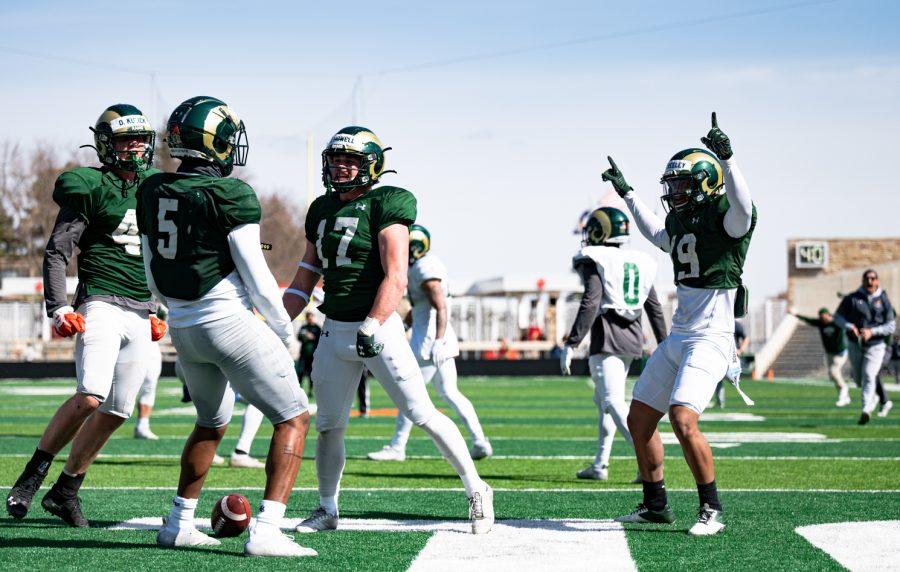 Colorado State University defensive squad celebrates in the end zone after an interception during practice in Canvas Stadium