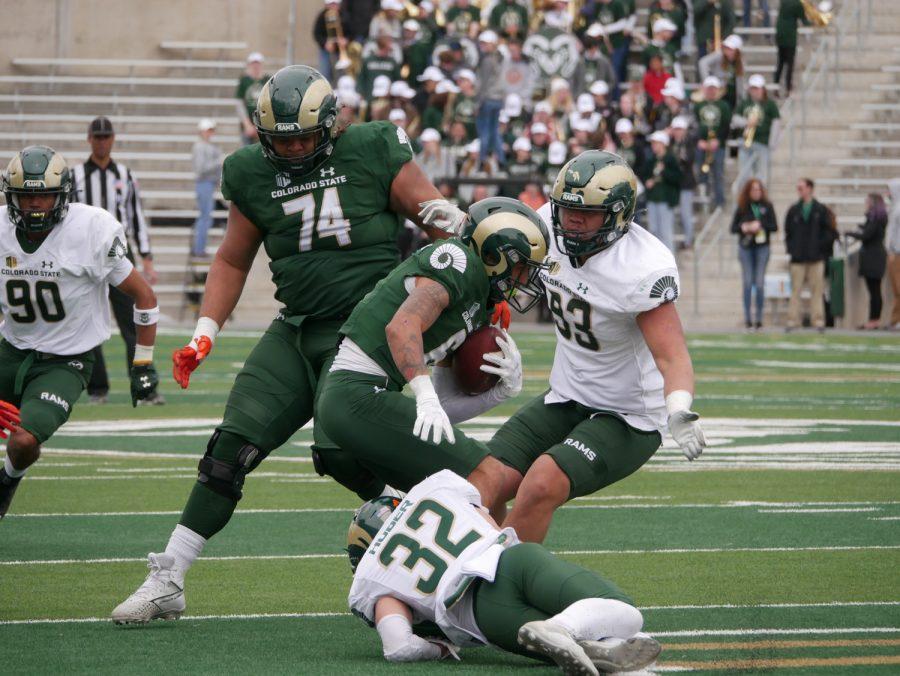Colorado State wide receiver Ty McCullouch (6) catches a pass as he is tackled by defensive back Liam Huber (32) April 23