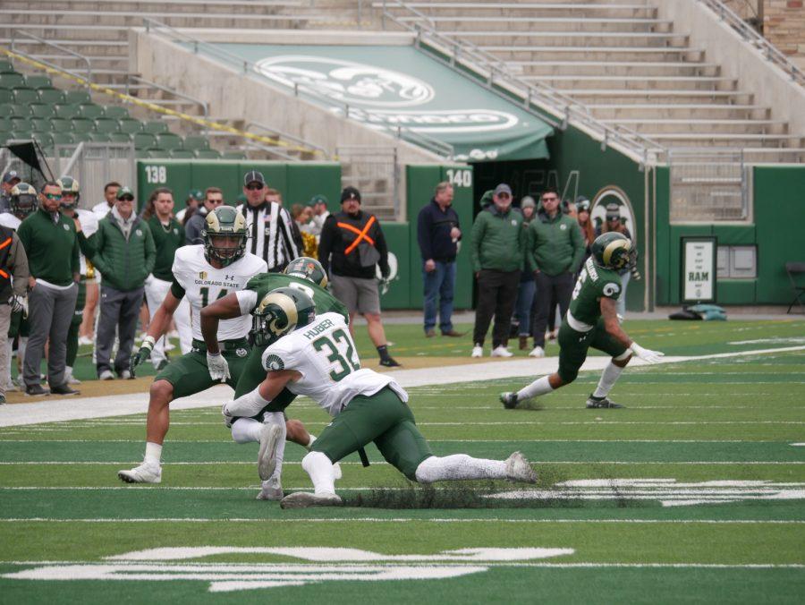 Colorado State wide receiver E.J. Scott is tackled by defensive back Liam Huber (32) April 23 in the Colorado State intra-squad scrimmage.