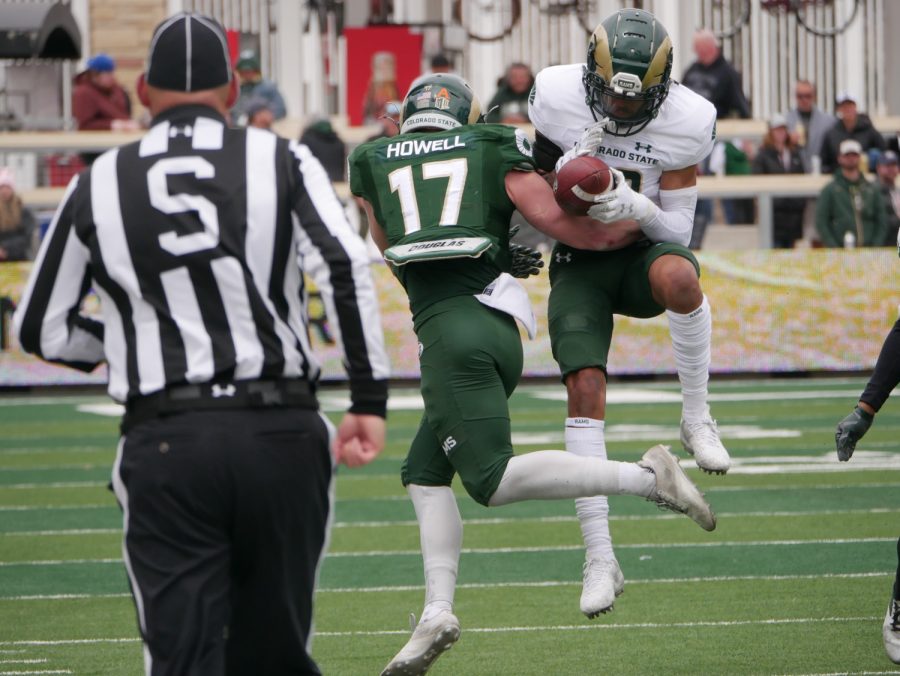 Colorado State wide receiver Logan Flinta (10) catches a pass as defensive back Jack Howell (17) tries to bring him down April 23.