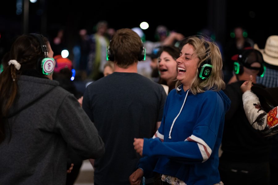 People in Old Town Square enjoying a silent concert during Fort Collins Music Experience April 22. Silent concerts are only heard through the headphones of the participants in the crowd, leaving only the outside noises of laughing, cheering and dancing.