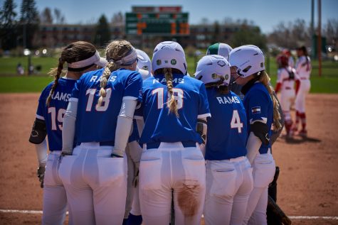 Members of the Colorado State softball team huddle closely due to cold weather during a time out April 10, 2022