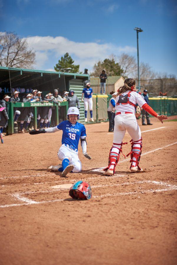 Junior, Makenna McVay, slides into home scoring a run from Peyton Allen's RBI April 10, 2022.
