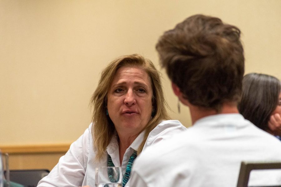 Larimer County Commissioner Jody Shadduck-McNally discusses sustainability in Fort Collins with a student at the Associated Students of Colorado State University Campus Community Roundtable April 21.