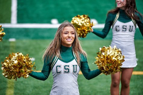 A member of the Colorado State University Golden Poms cheers on the sideline during Green and Gold Weekend