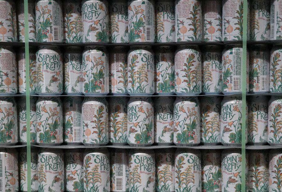 A+tower+consisting+of+only+Sippin+Pretty+cans+sit+stacked+on+top+of+each+other+in+the+packaging+section+of+the+Odell+Brewing+Company+April+6.