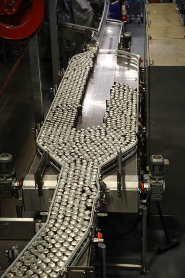 Cans of 90 Schilling are sorted along the the way to being packaged April 6.