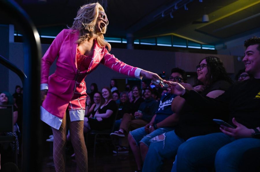 During their performance, Lulu Alnite takes a cash donation from the hands of an audience member