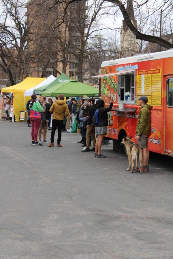 Fort Collins residents visit food trucks at the Fort Collins Earth Day Festival.
