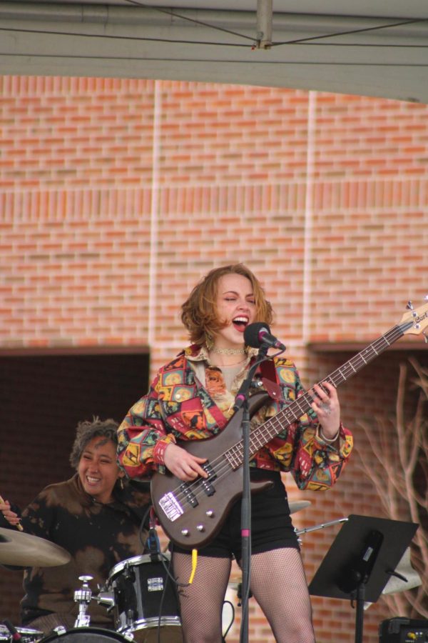 The lead singer of local band May Be Fern sings and plays the guitar at the Fort Collins Earth Day Festival.