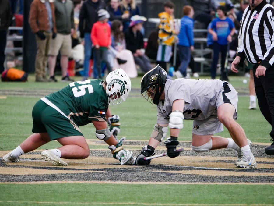 Colorado State Face off specialist Christoper Reed (25) battles for possession with University of Colorado FOS Willis Hanson (13) April 16.