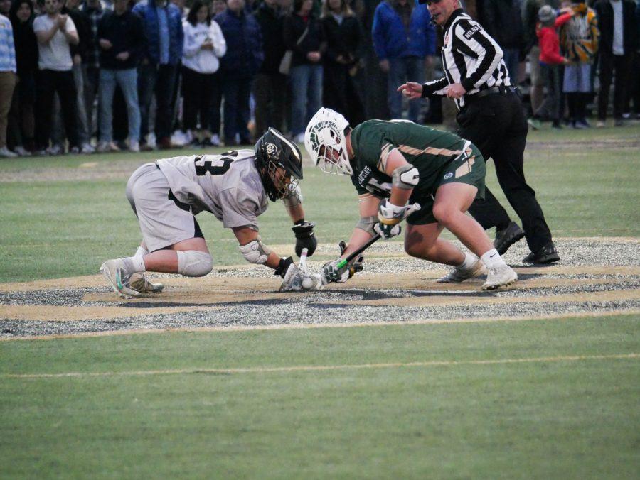 Colorado State Face off specialist Christoper Reed (25) battles for possession with University of Colorado FOS Willis Hanson (13) April 16.