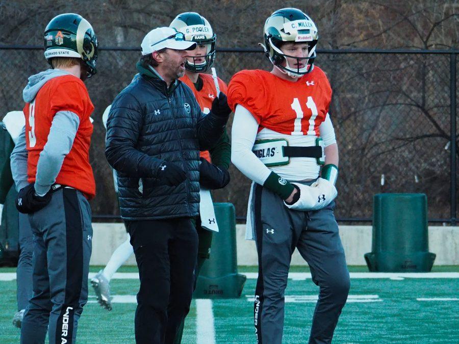 Associate Head Coach and quarterbacks coach Matt Mumme talks with quarterback Clay Millen (11) between drills March 31, 2022.
