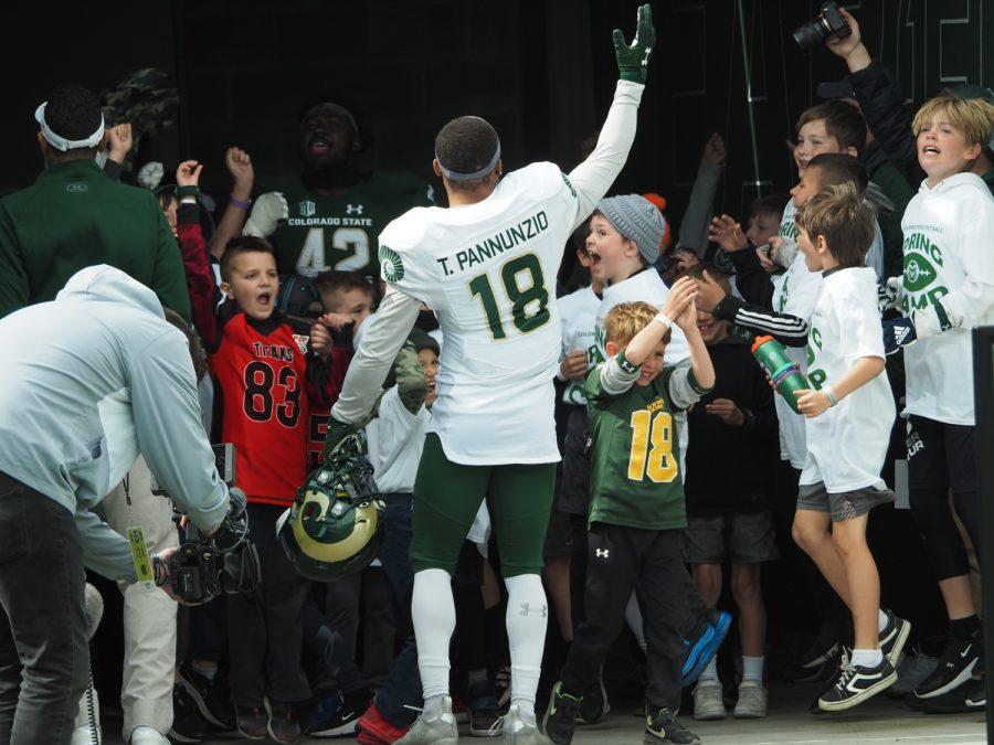 Colorado State wide receiver Thomas Pannunzio (18) hypes up the participants of a youth clinic put on by Colorado State football April 23