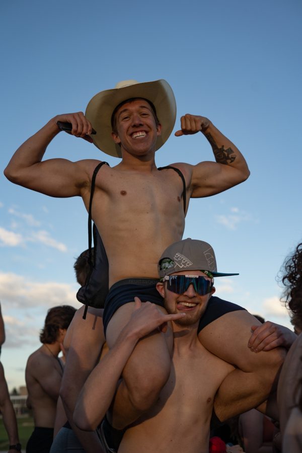 Logan Eastwood sits atop Todd Osobas shoulders to pose during the Undie Run gathering on the intramural fields