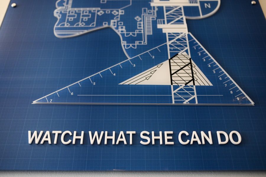 The WATCH WHAT SHE CAN DO mural hangs inside of Guggenheim Hall