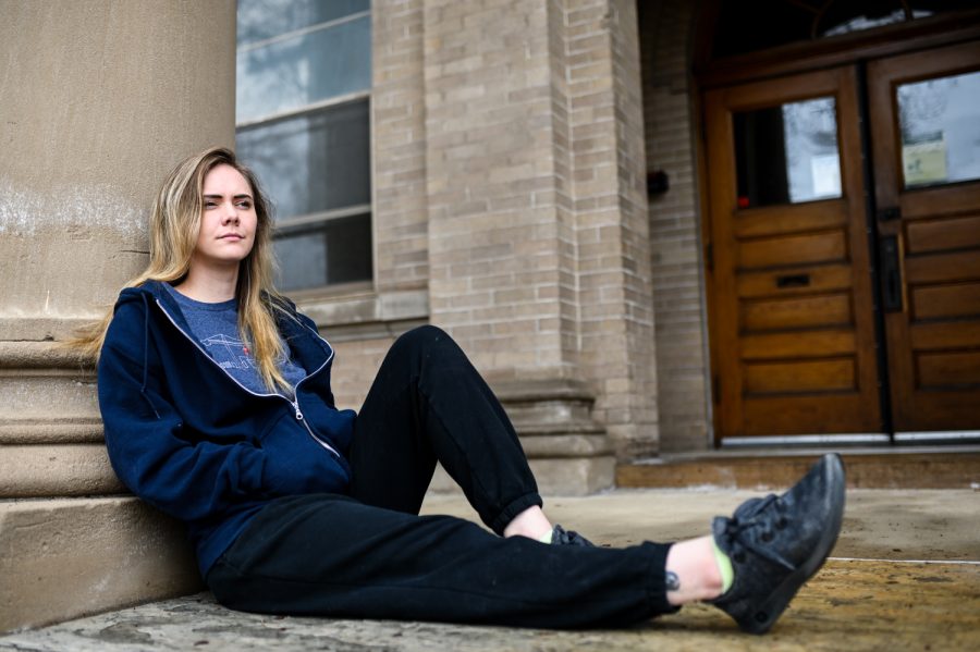 Senior Ren Bergeron sits in front of the Simon Guggenheim Hall of Household Arts
