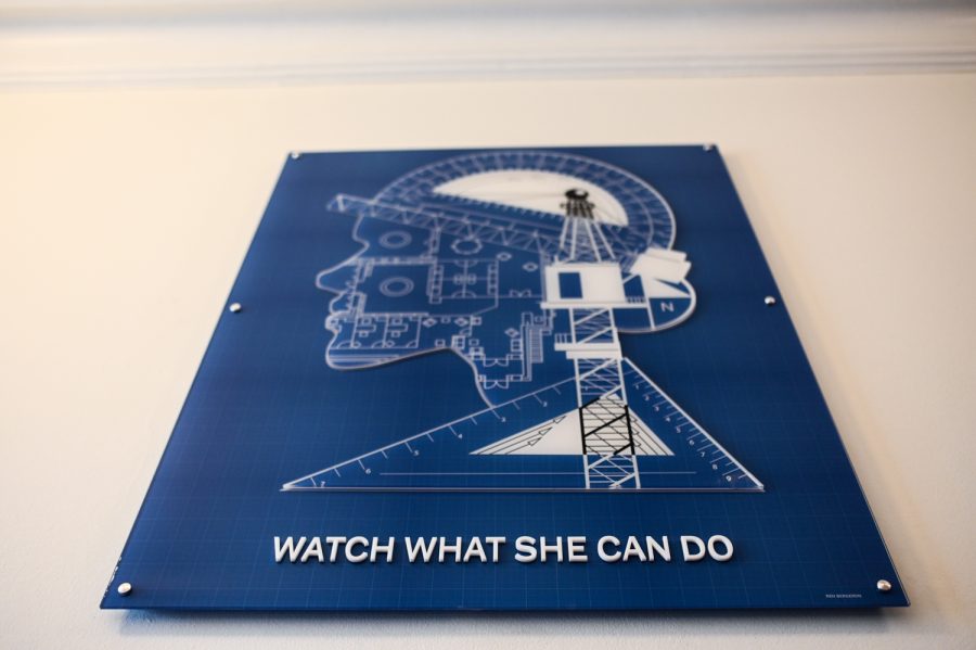 The WATCH WHAT SHE CAN DO mural hangs inside of Guggenheim Hall