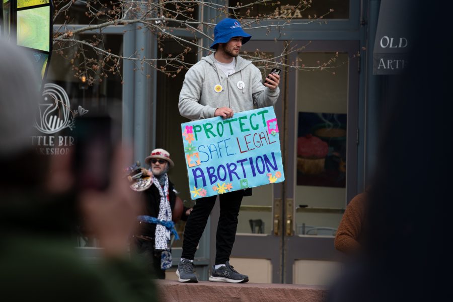 Benton Roesler, a fith year at Colorado State University, holds a sign reading, Protect safe legal abortion at a protest in Fort Collins Colorado Old Town against the Supreme Courts decision to overturn Roe Versus Wade May 3.