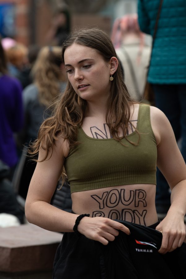 Amanda Elvins attends a protest of the Supreme Courts descion to overturn Roe V Wade the words "Not Your Body" written on her body May 3.