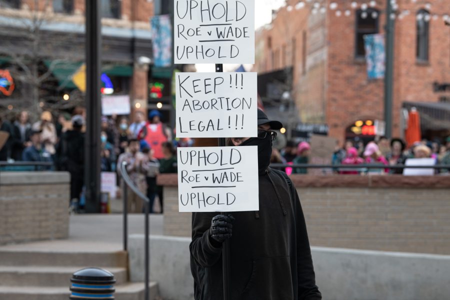 Dave Outlandish holds up a sign at a protest in Fort Collins Colorado Old Town against the Supreme Courts decision to overturn Roe versus Wade May 3.