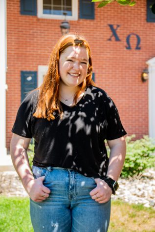 Mckenna Daly, President of Chi Omega in front of the sorority home