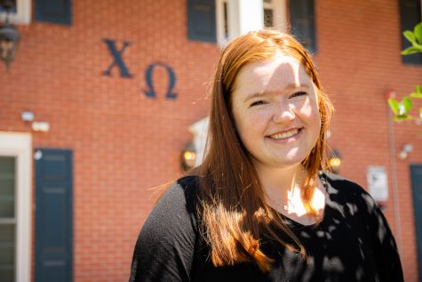 Mckenna Daly, President of Chi Omega in front of the sorority home