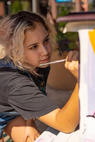 Athena Koss focuses on painting her piano.