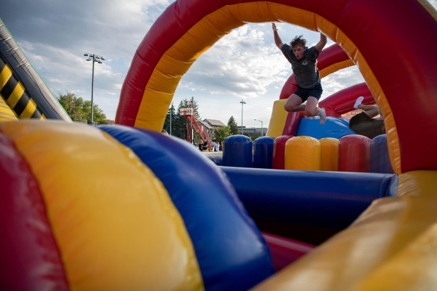 Participants of the Colorado State University Ram Welcome race through inflatable obstacle courses on the intermural fields Aug. 18
