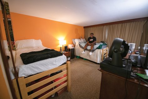 Julian Gordon sits on his dorm room bed inside the Fort Collins Best Western University Inn