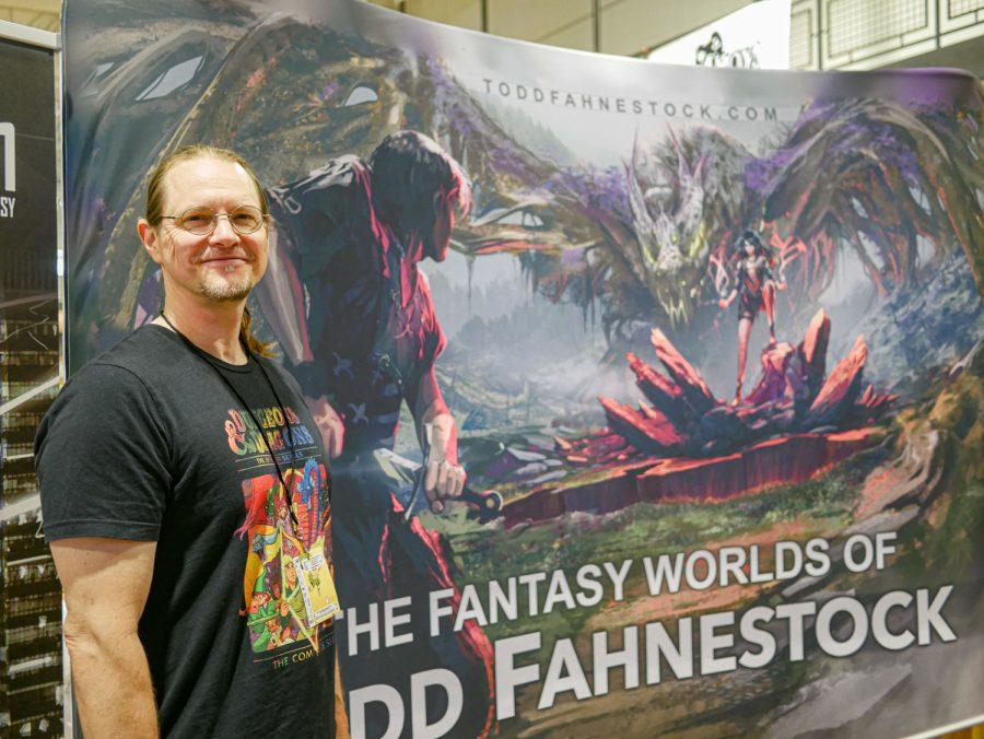 Author Todd Fahnestock, author of the fantasy series ‘Threadweavers’ stands at his table at the Fort Collins Comic Con