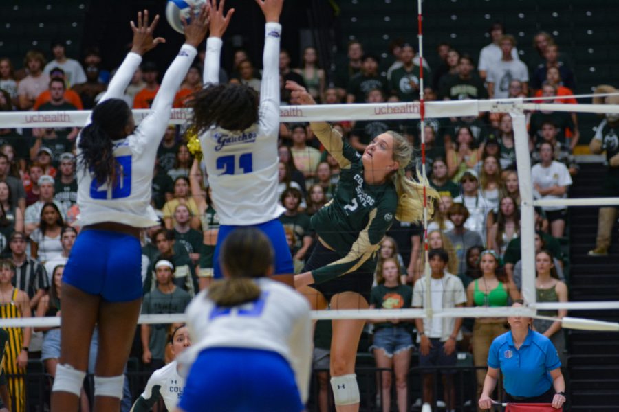 Colorado State outside hitter Annie Sullivan attempts to kill the ball while two University of California, Santa Barbara players attempt to block her