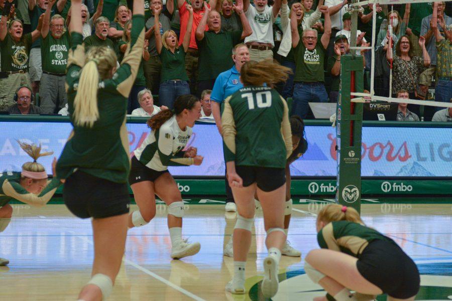 Members of the Colorado State University volleyball team and fans in attendance at Moby Arena celebrate the match point being scored in the CSU volleyball game against the University of California, Santa Barbara