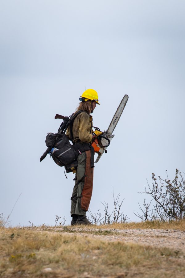 A wildland fire fighter gears up to fight the County Road 21 fire in Fort Collins Colorado