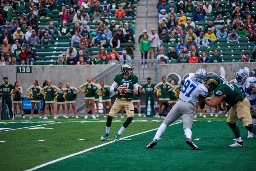 Colorado State University quarterback Clay Millen (11) looks for an open pass during the season opener game against Middle Tennessee State University