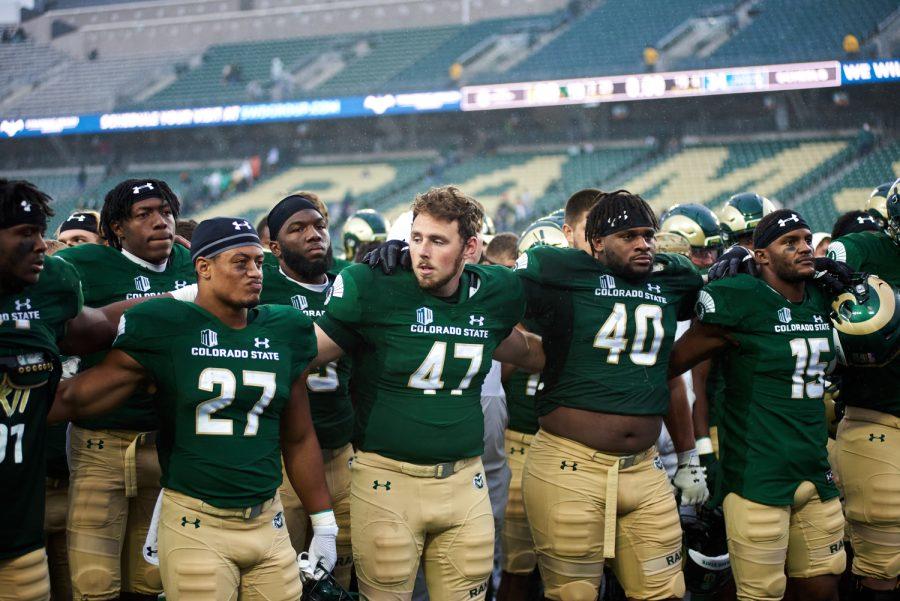 The Colorado State University football team locks arms while the CSU alma mater song plays at the end of the season opener game against Middle Tennessee State University at Canvas Stadium