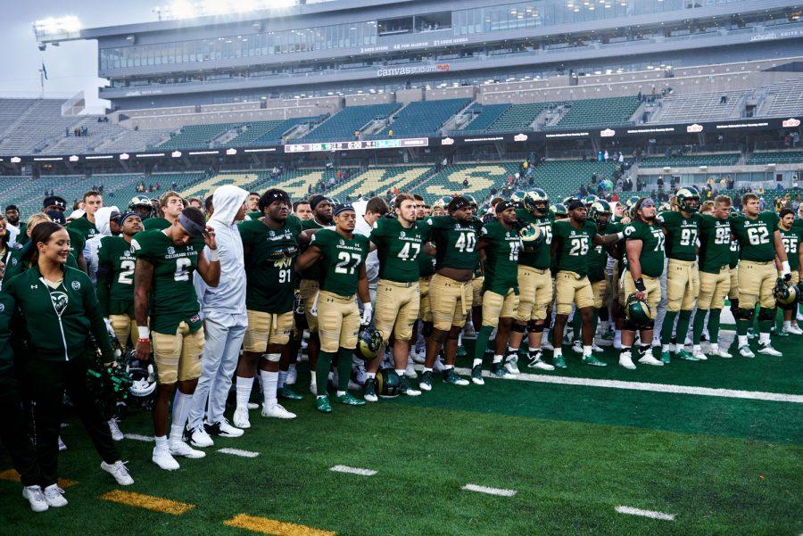 The Colorado State University football team locks arms while the CSU alma mater song plays at the end of the season opener game against Middle Tennessee State University at Canvas Stadium