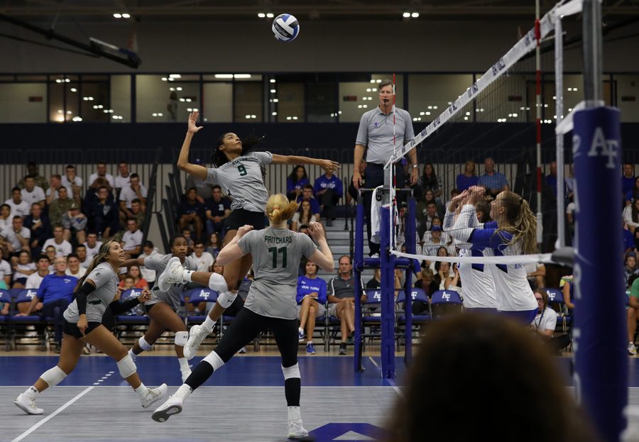 Naeemah Weathers (9), a Colorado State University middle blocker, spikes the ball to gain a point against the United States Air Force Academy Falcons in Colorado Springs, Colorado, Sept. 29. The Rams won the match 3-0.