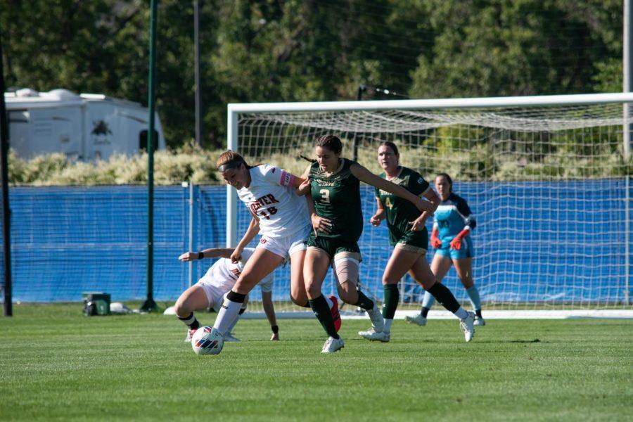 Colorado State defender Izzy Wildermuth attempts to get the ball from University of Denver midfielder Sami Feller (18) Sept. 11